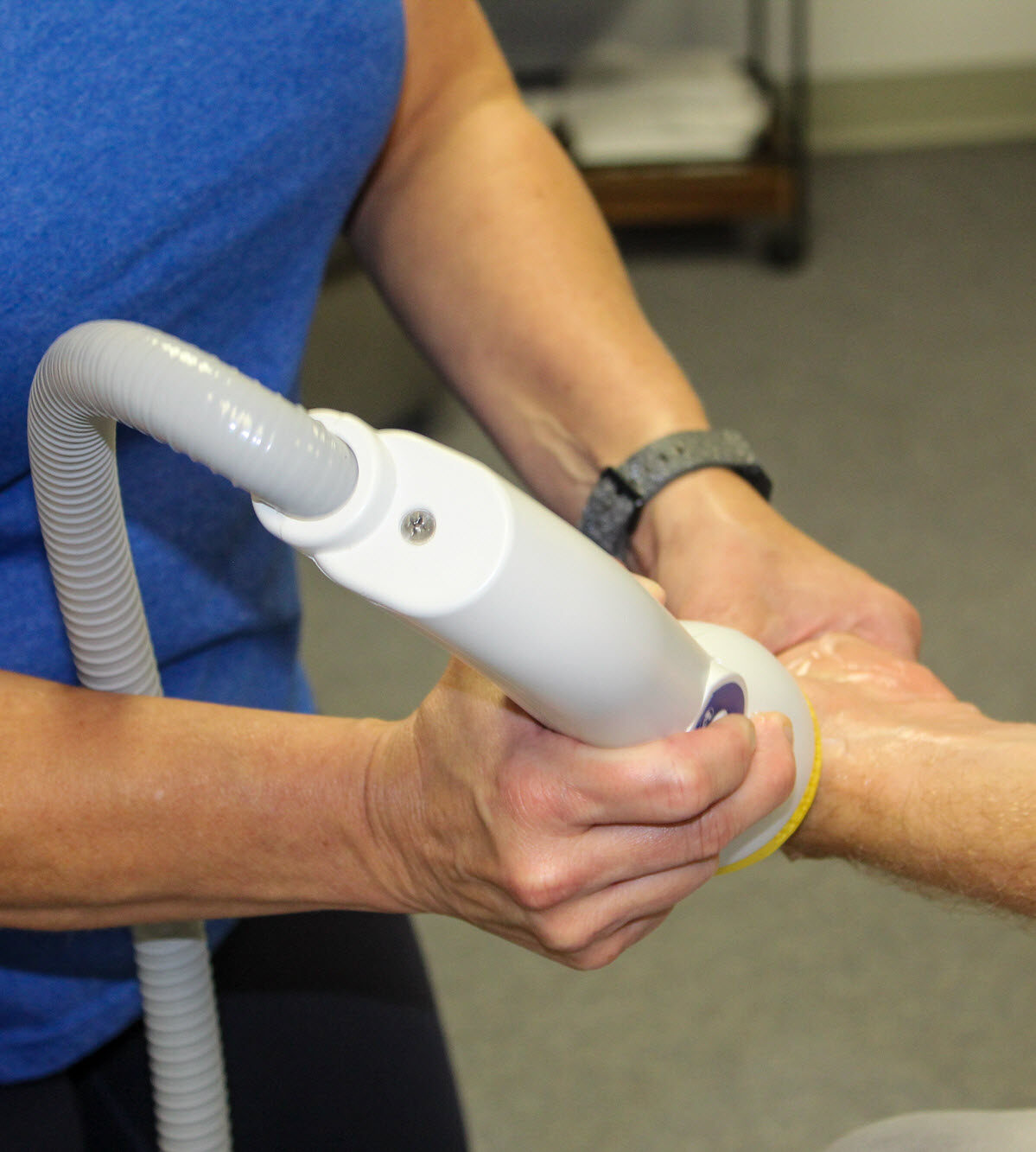Picture of a person receiving SoftWave Therapy on their left wrist.