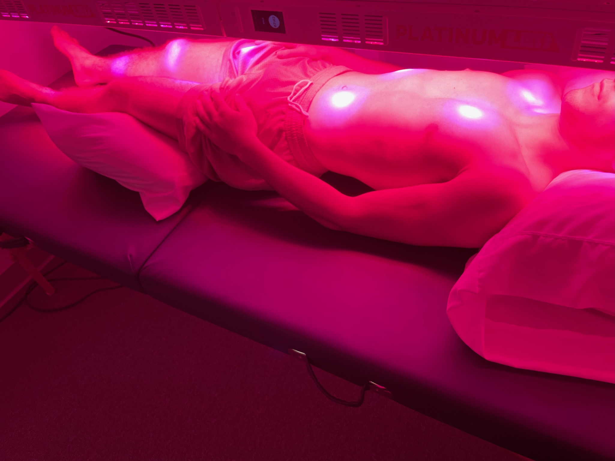 Picture of a man receiving Red Light Therapy.